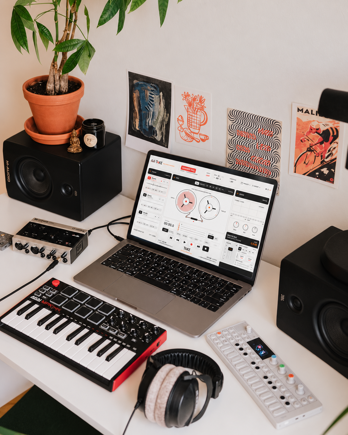 T4KE in a music setup with MacBook, controller and speakers